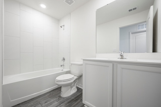 full bathroom with tiled shower / bath combo, toilet, and vanity