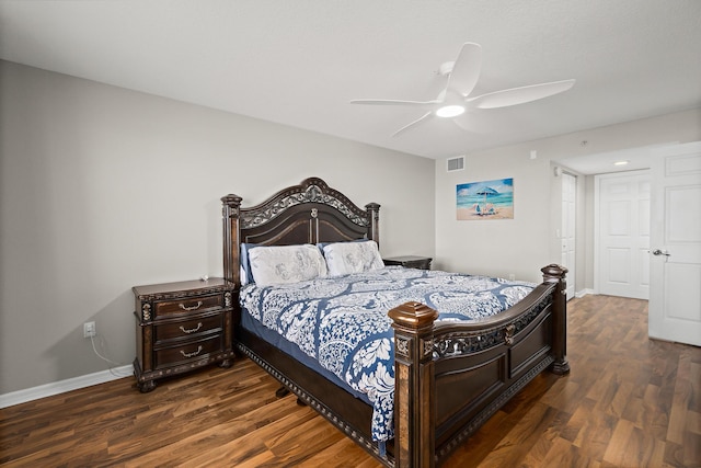 bedroom featuring a ceiling fan, dark wood finished floors, visible vents, and baseboards