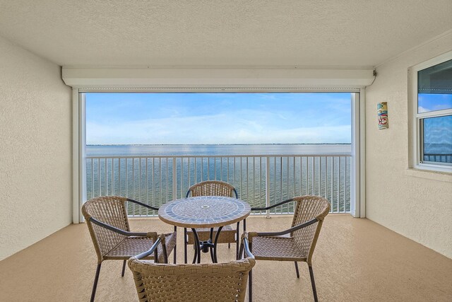 balcony featuring a water view