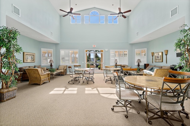 carpeted dining space featuring ceiling fan and visible vents