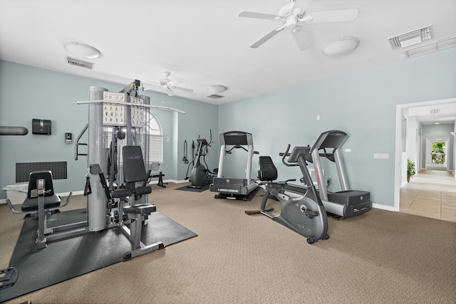 gym with baseboards, carpet flooring, visible vents, and a ceiling fan