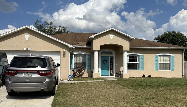 ranch-style home with a garage and a front lawn