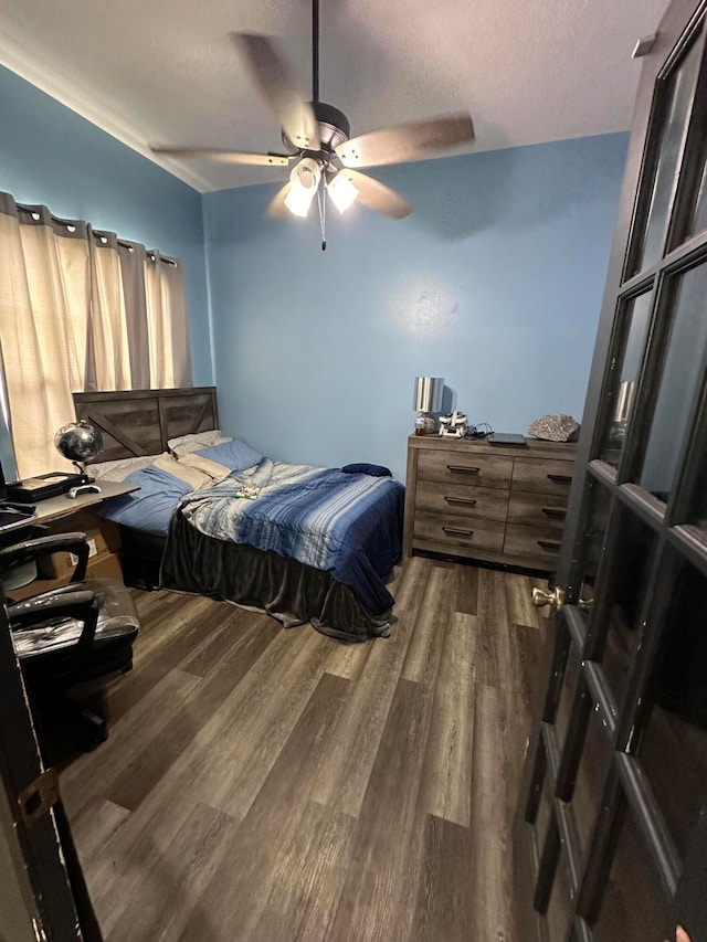 bedroom featuring ceiling fan and dark hardwood / wood-style floors