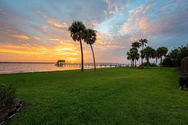 yard at dusk with a water view