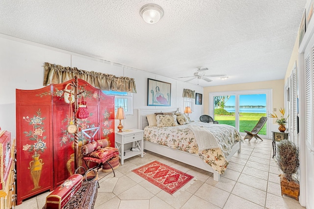 bedroom with tile patterned flooring, a textured ceiling, access to exterior, and ceiling fan