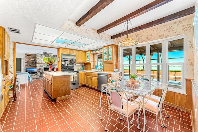 kitchen with dishwasher, ceiling fan, range with electric stovetop, a brick fireplace, and decorative light fixtures