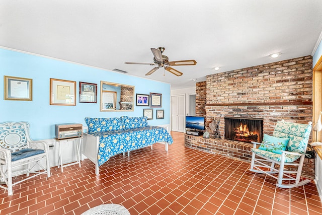 living room featuring ceiling fan, a fireplace, and a textured ceiling