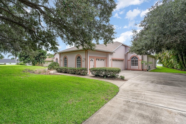 view of front of home featuring a garage and a front lawn