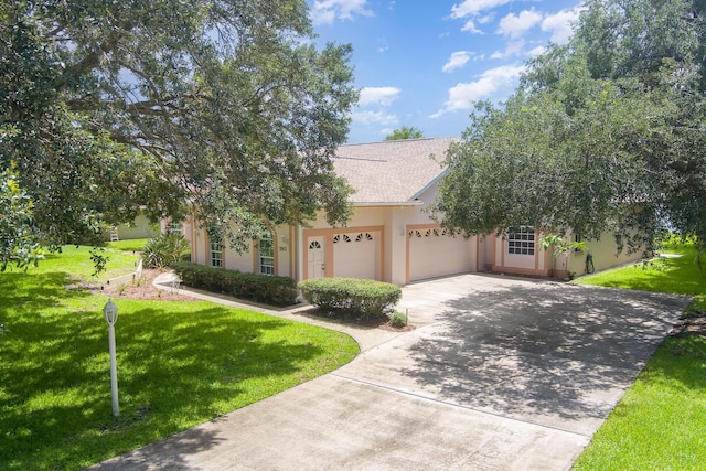 view of front of property with a garage and a front yard