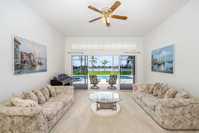 carpeted living room with ceiling fan