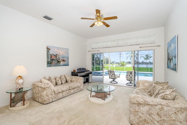 carpeted living room with ceiling fan