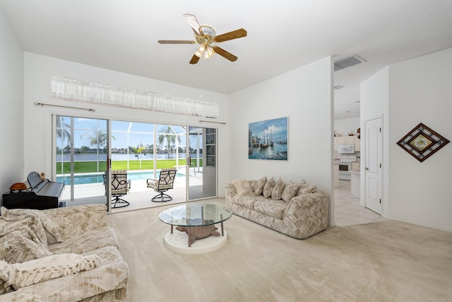 carpeted living room with ceiling fan