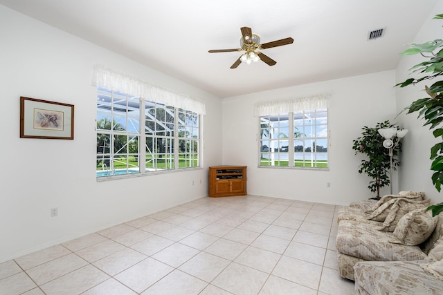 interior space featuring plenty of natural light, ceiling fan, and light tile patterned floors