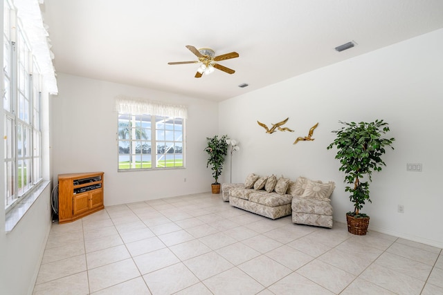 sitting room with ceiling fan and light tile patterned flooring