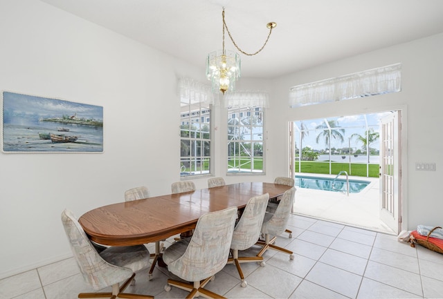 tiled dining room with an inviting chandelier