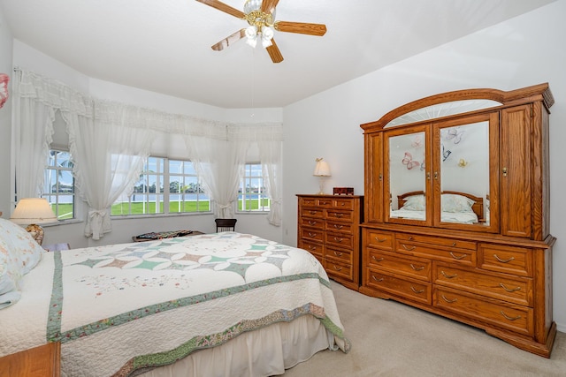 bedroom with light carpet and ceiling fan