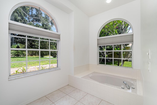 bathroom featuring tiled bath and tile patterned floors