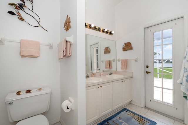 bathroom with tile patterned floors, vanity, and toilet