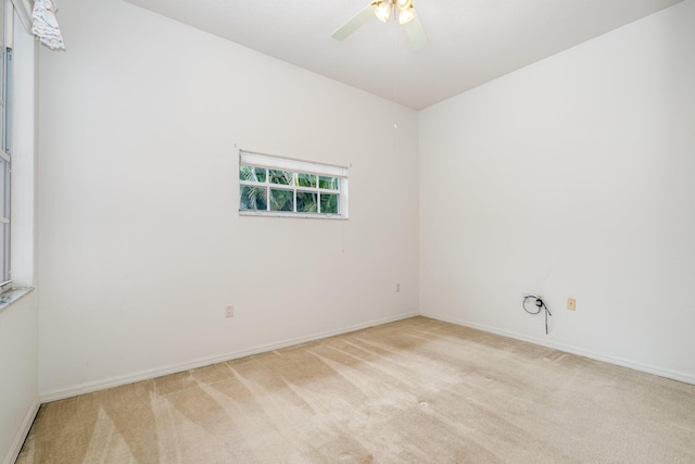 unfurnished room featuring light carpet and ceiling fan