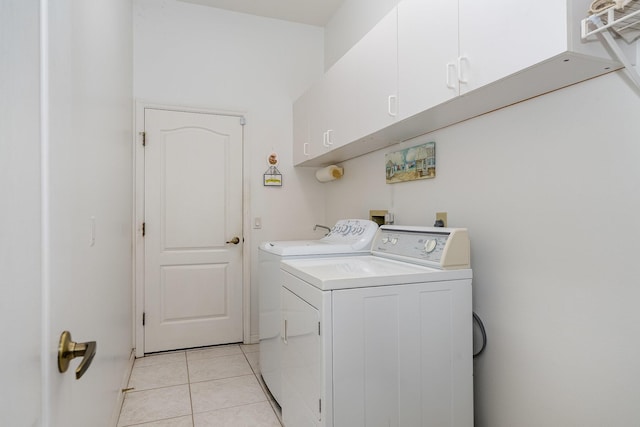 washroom featuring cabinets, independent washer and dryer, and light tile patterned floors