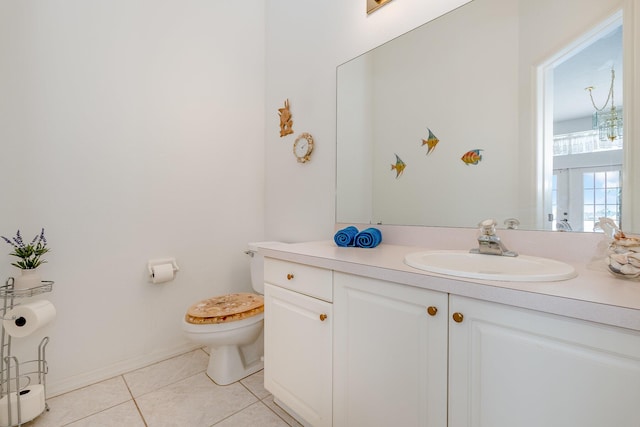 bathroom featuring tile patterned flooring, vanity, and toilet