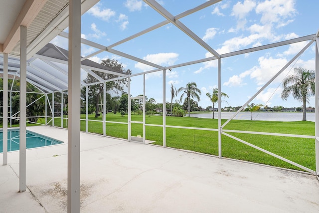 view of swimming pool with a lanai, a patio area, a water view, and a yard