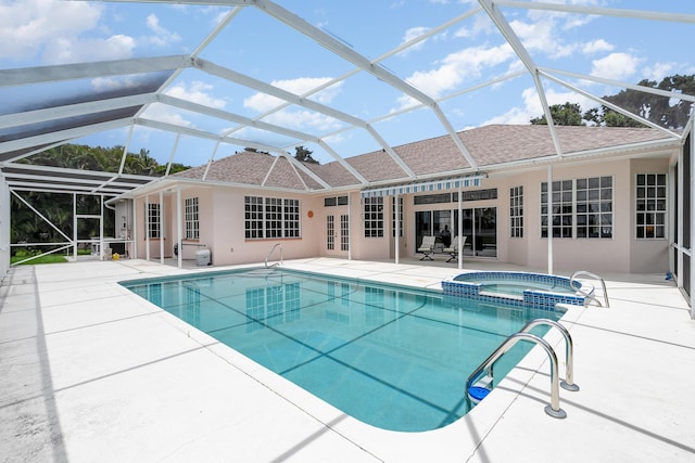 view of swimming pool with a lanai, a patio, an in ground hot tub, and french doors