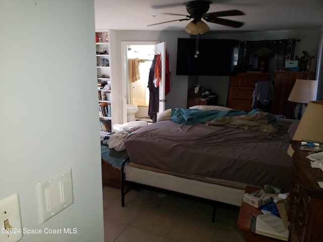 tiled bedroom with ensuite bathroom and ceiling fan