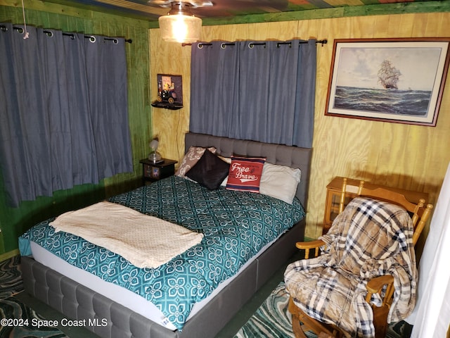 bedroom with wooden walls