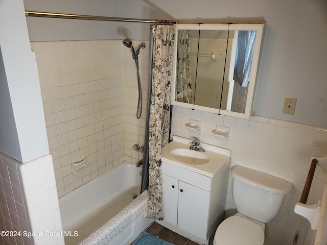 full bathroom featuring shower / tub combo with curtain, vanity, tile walls, and toilet