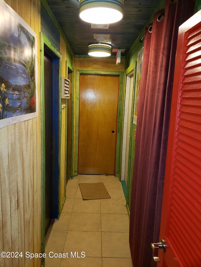 hall featuring light tile patterned flooring