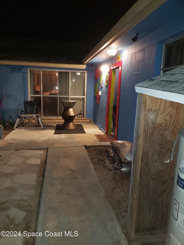 patio at twilight featuring electric water heater