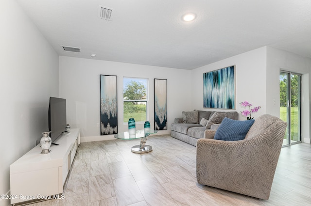 living room with a textured ceiling and plenty of natural light