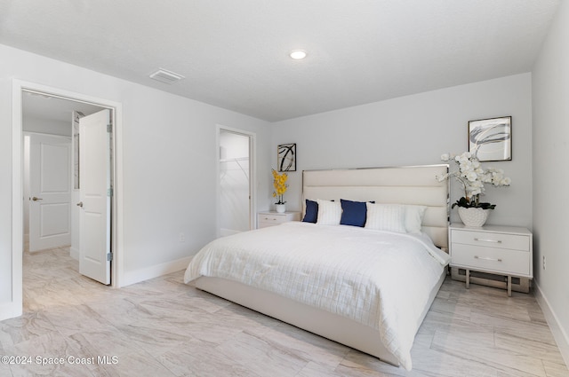 bedroom featuring a walk in closet