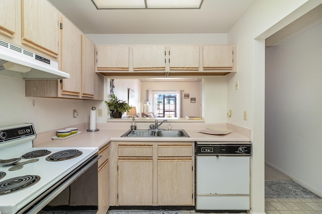 kitchen featuring light brown cabinets, white appliances, and sink