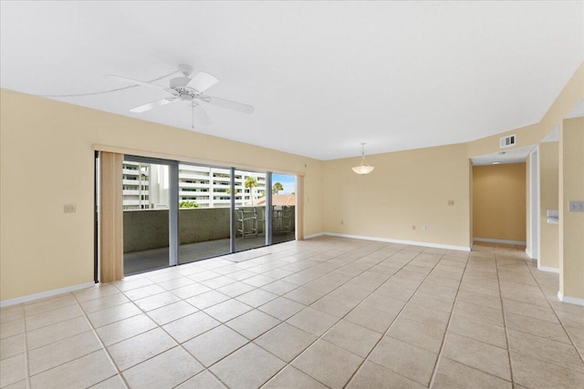 tiled spare room with ceiling fan