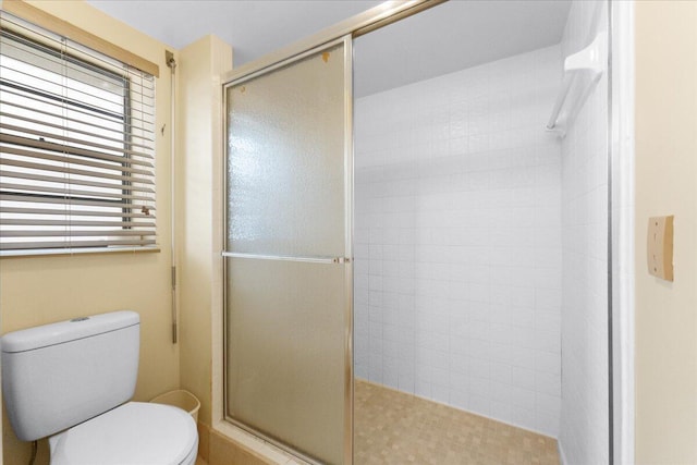 bathroom featuring toilet and walk in shower