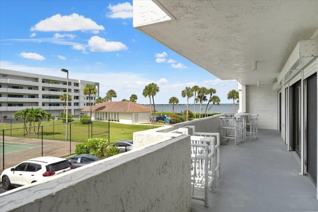 balcony with exterior bar and a water view