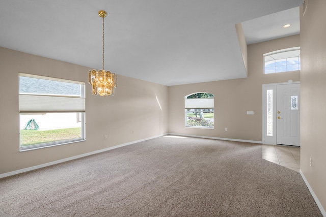 interior space featuring light carpet and a chandelier