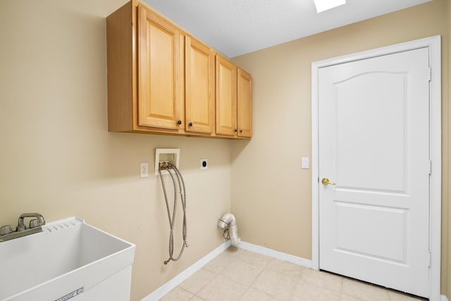 laundry room featuring sink, cabinets, hookup for an electric dryer, hookup for a washing machine, and a textured ceiling