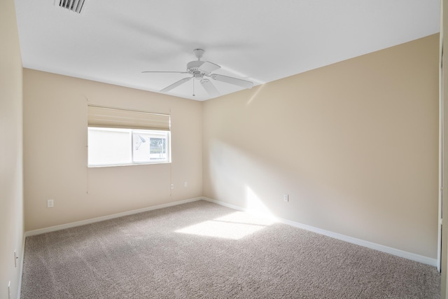 carpeted spare room with ceiling fan