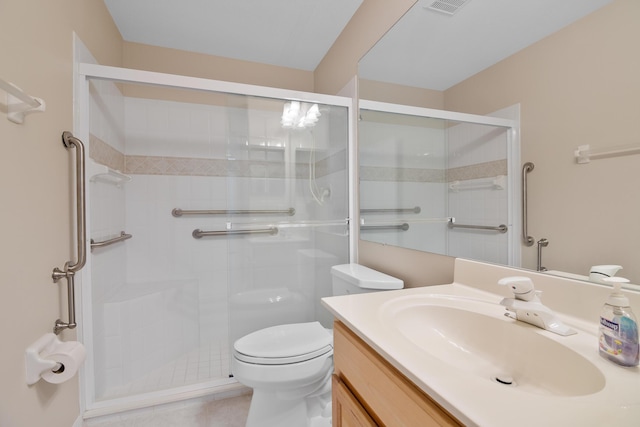 bathroom featuring vanity, an enclosed shower, and toilet