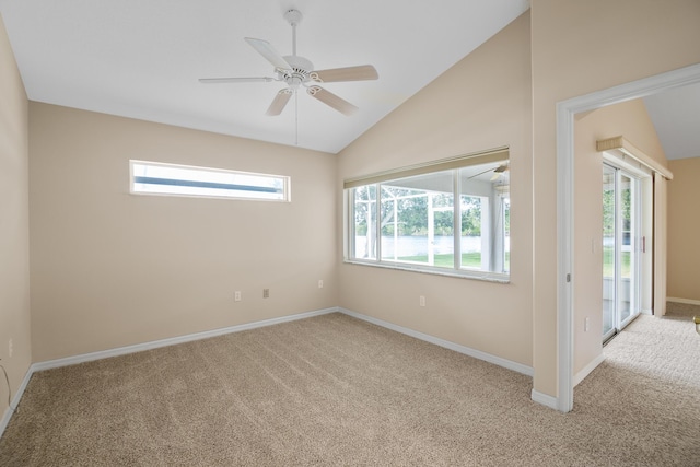 carpeted empty room featuring vaulted ceiling and ceiling fan