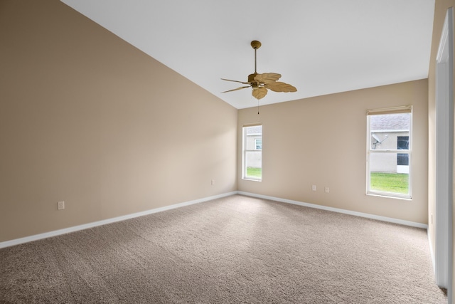 carpeted spare room featuring plenty of natural light, lofted ceiling, and ceiling fan