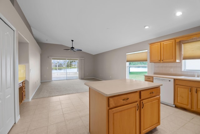 kitchen featuring a wealth of natural light, dishwasher, a kitchen island, and vaulted ceiling