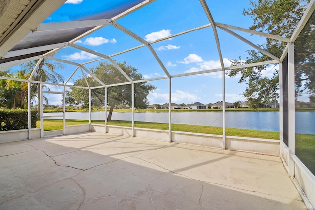 view of patio featuring a lanai and a water view