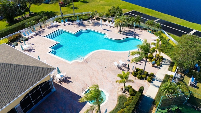 view of pool featuring a water view and a patio