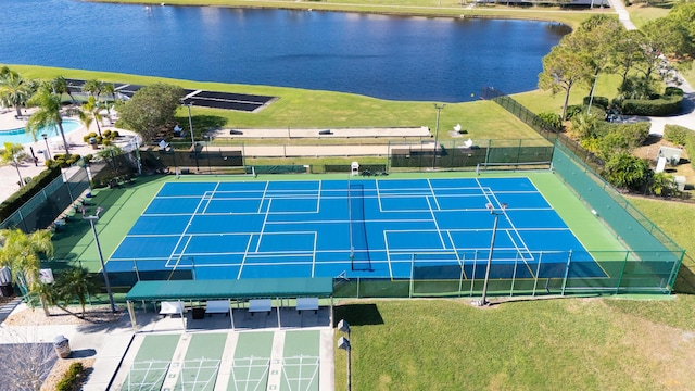 view of sport court with a water view