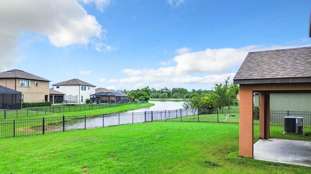 view of yard with central air condition unit, a gazebo, and a water view