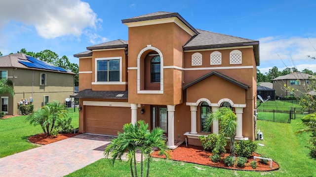 view of front of property with a garage and a front yard